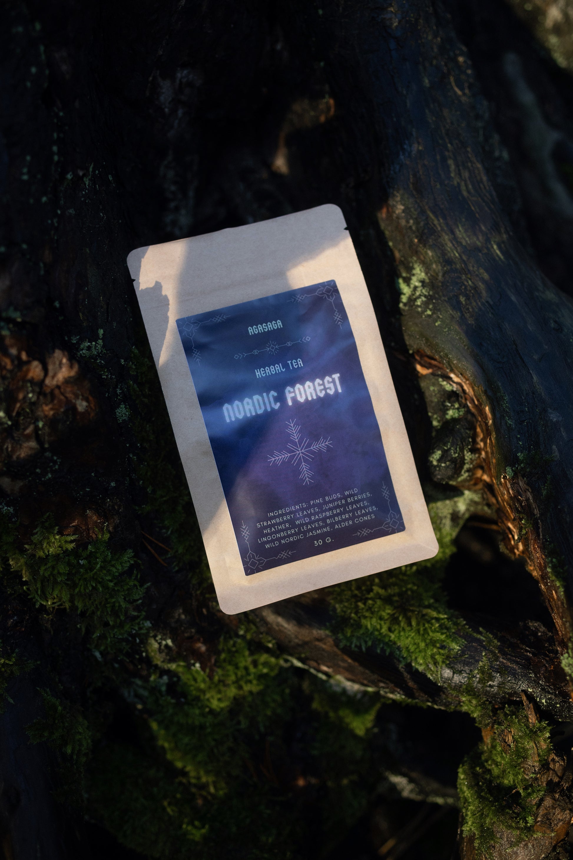 Tea package labeled "AGASAGA forest" on a mossy surface.